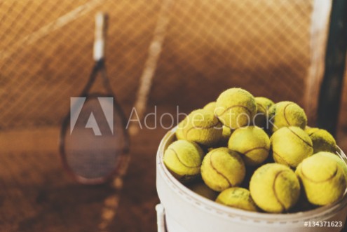 Picture of Tennis balls at hopper tennis racket in the blurred background sportive and healthy lifestyle